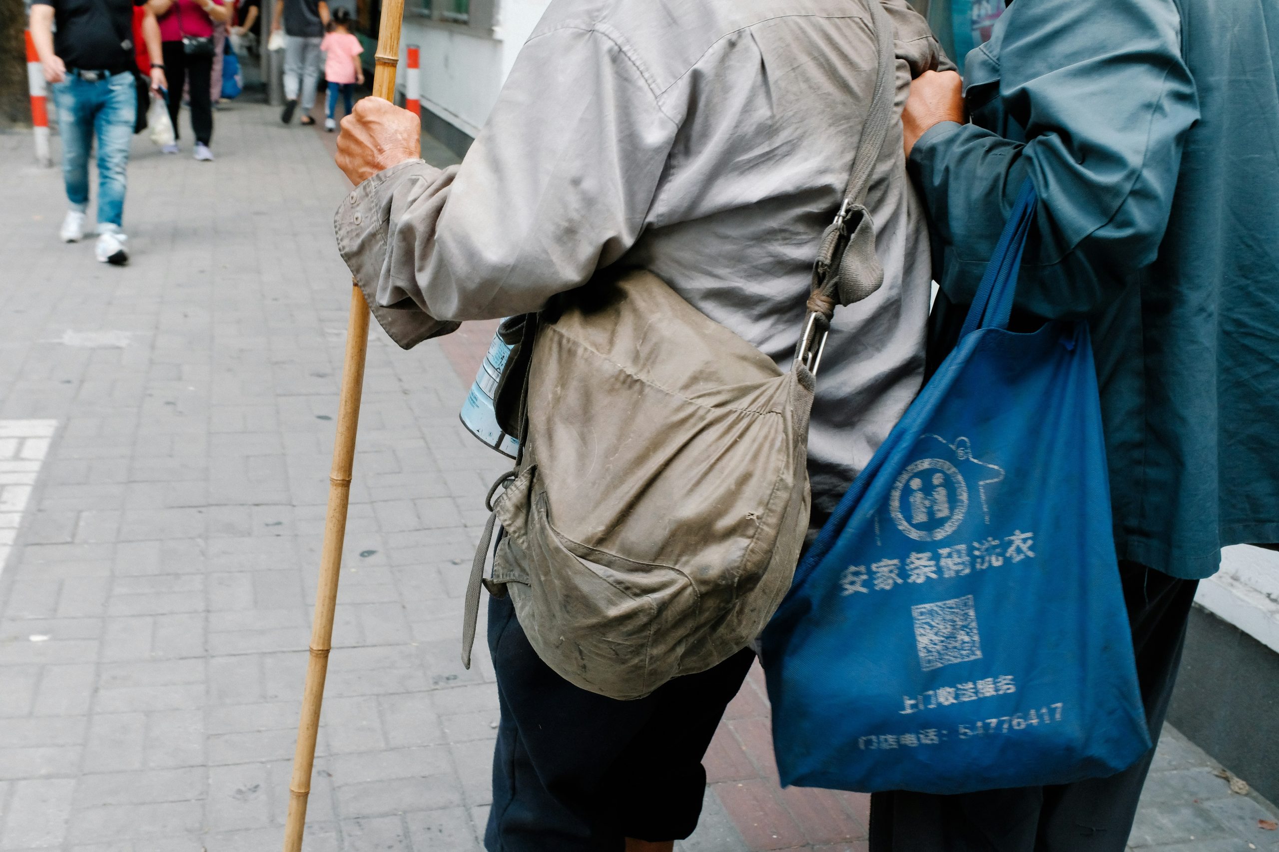 Person struggling with oversized umbrella while traveling