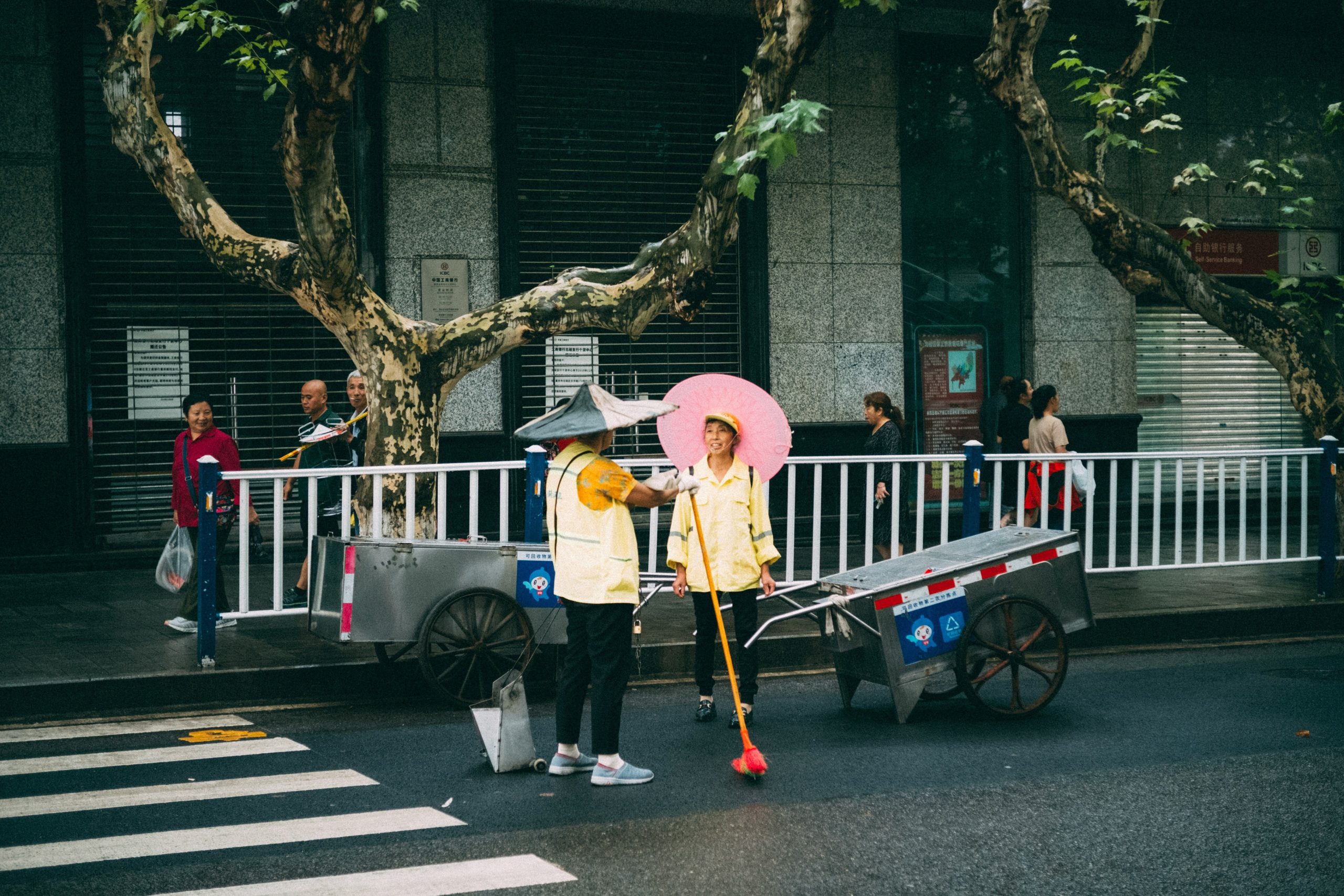 smiling female traveler biking in light rain wearing sleek rain jacket