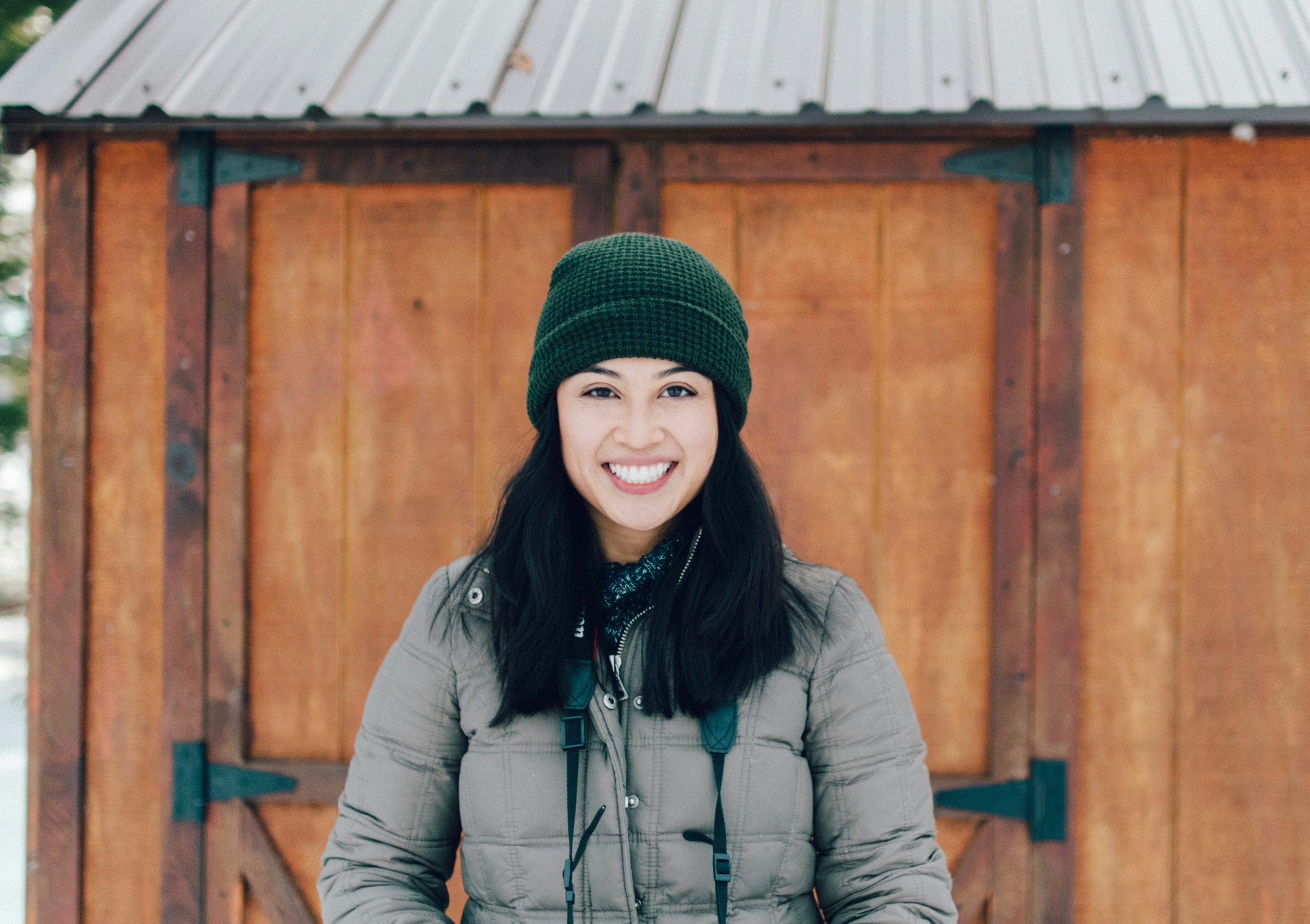 Tina smiling while hiking in heavy rain